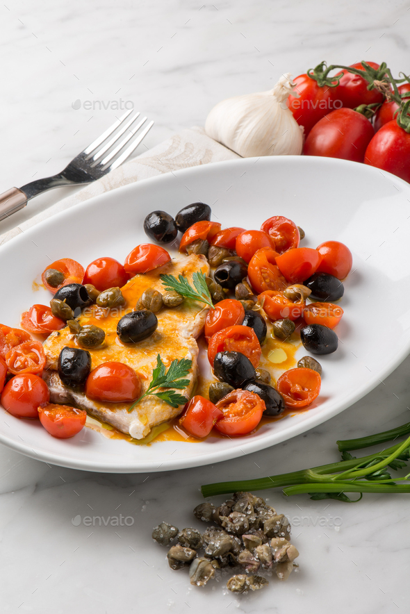 swordfish with tomatoes capers and olive Stock Photo by